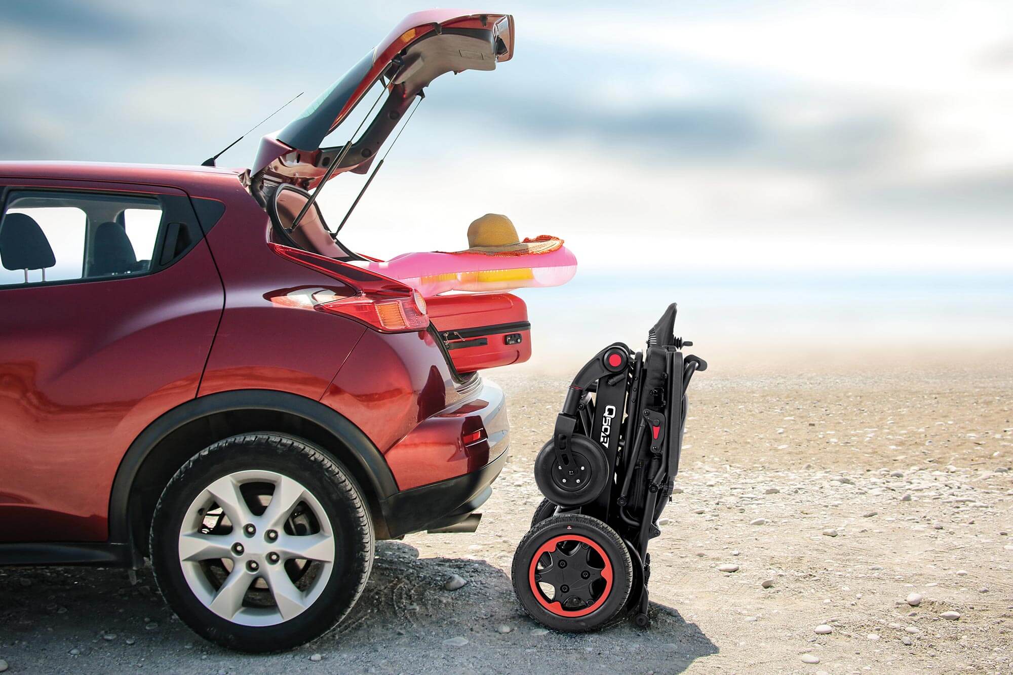 Folded Q50R Powerchair next to car boot Derby Mobility